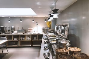 A modern kitchen with stainless steel appliances, a long counter, and overhead lighting. - Homeinn Ripple Yun Hotel (Shiyan Chezhan Road) (Shiyan)