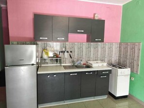 Fridge, microwave, cookware/dishes/utensils, dining tables