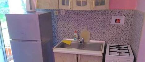 Fridge, cookware/dishes/utensils, dining tables