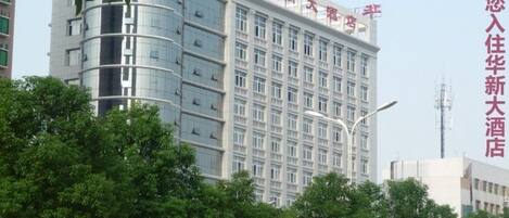 A multi-story hotel building with a modern design, featuring a prominent sign at the top.