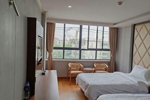 A hotel room with a bed, a desk, a chair, and a window. - Yun Hai Hotel (Shanghai)