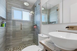 Een douche, handdoeken, zeep, toiletpapier