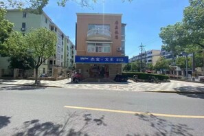 A building with a blue signboard, a balcony, and a clear sky. - Jujia Hostel (Shanghai)