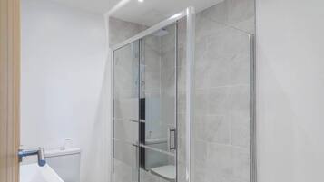 Shower, hair dryer, towels, shampoo