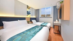 A hotel room with two beds, a small bedside table, a wall-mounted TV, and a window with a view. - Youyue Selected Hotel (Beijing South Station Temple of Heaven South Gate Branch) (Beijing)