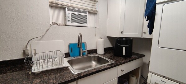 Fridge, microwave, coffee/tea maker, cookware/dishes/utensils