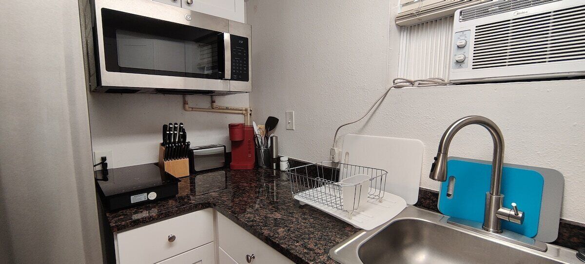 Fridge, microwave, coffee/tea maker, cookware/dishes/utensils