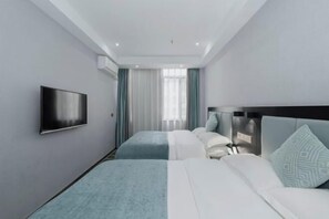 A hotel room with a flat-screen TV, two beds with different bedding, a headboard, and a window with curtains. - Longxiang Deluxe Hotel (Fangchenggang Administration Center) (Fangchenggang)