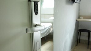 A modern bathroom with a toilet, a hand dryer, and a small stool. - 100 Inn (Small Shanghai pedestrian street) (Shanghai)