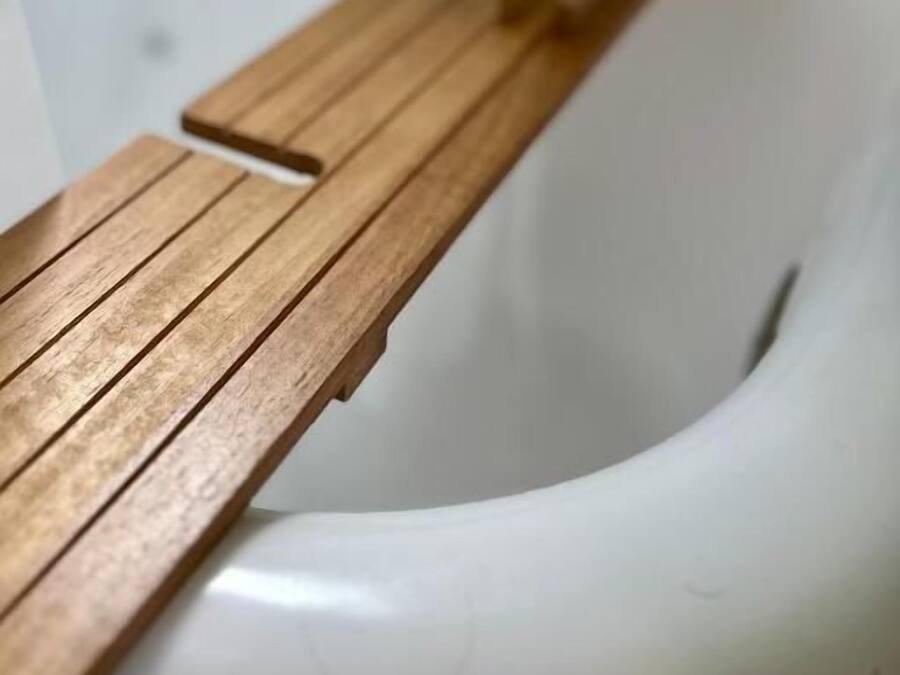 A white sink with a wooden countertop.