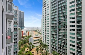 A high-rise building with multiple balconies and a view of the ocean. - Chic Downtown Studio With Rooftop Pool and Gym (Miami)