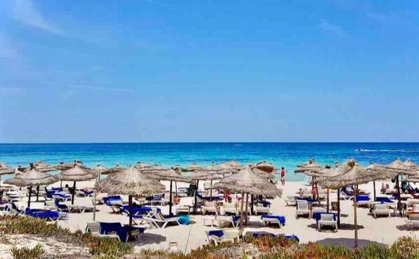 On the beach, sun-loungers