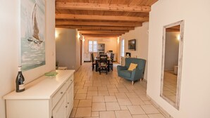 A spacious living area with a wooden ceiling, a dining table, and a sofa. - Villa Casa Blu (Kvarner - Kras) (Kras)