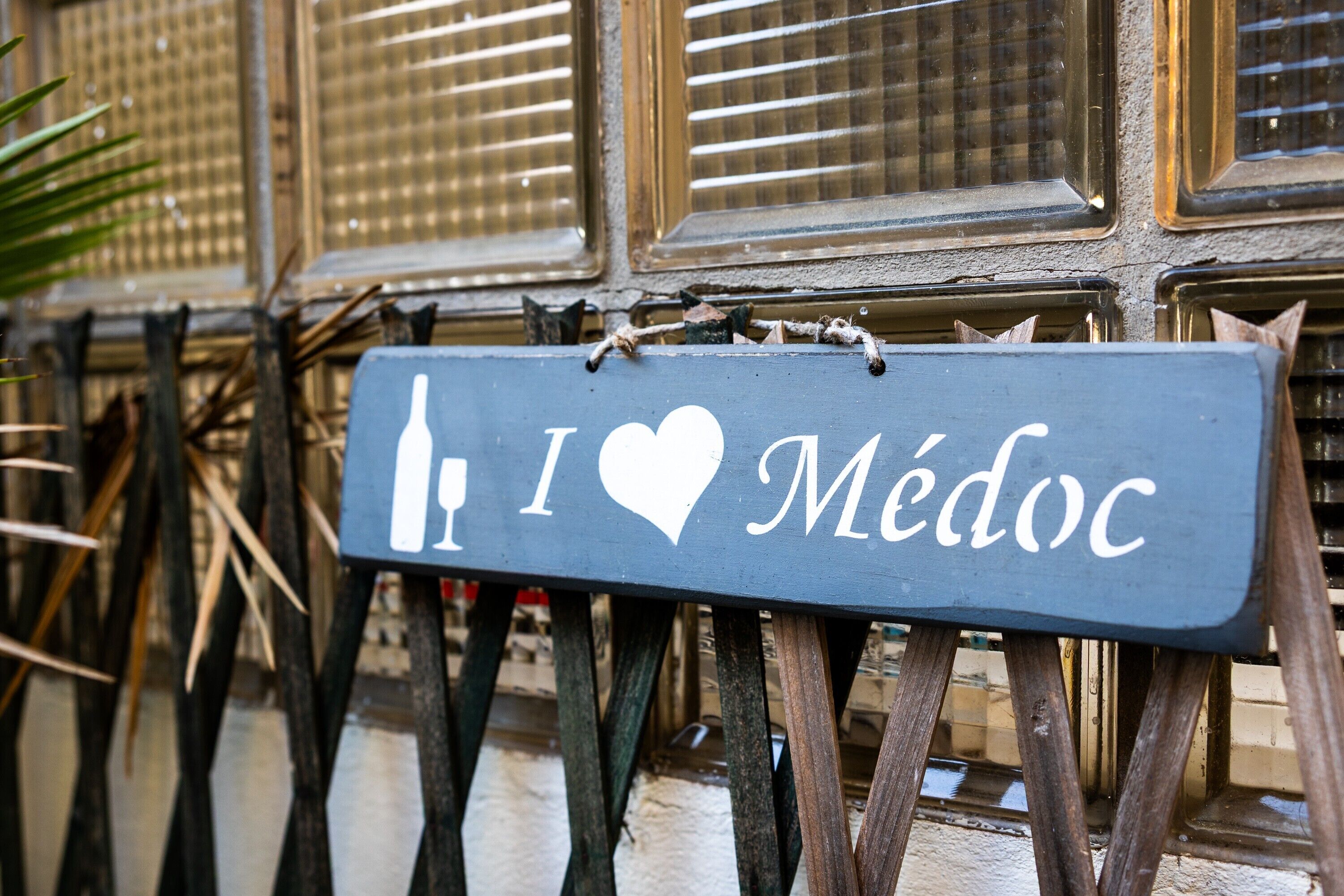 A sign with the text 'I ♥ Médoc' mounted on a wooden structure.