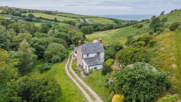 A rural house with a gravel driveway, surrounded by lush greenery and hills. - Cwmtawel, Holiday Cottage Ceibwr Bay, Sleeps 4, 3 bedrooms,  bathrooms (Cardigan)