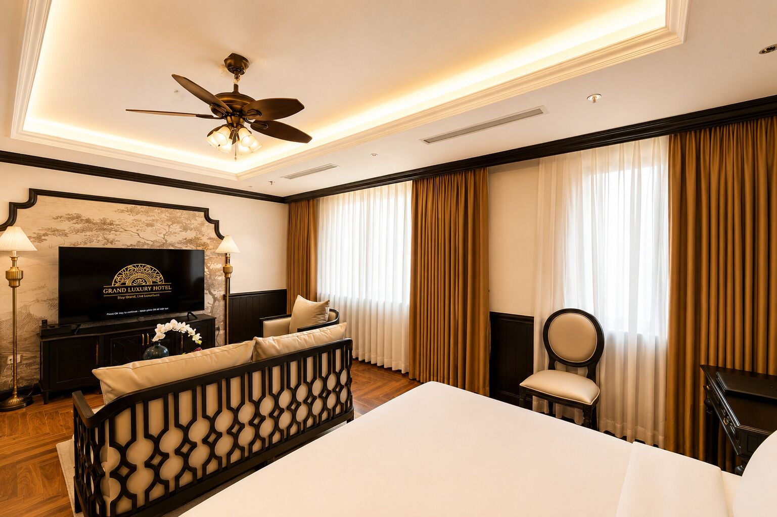 A hotel room with a bed, a television, a desk, a chair, and a ceiling fan.