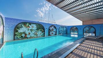 Kolam renang indoor, dengan payung kolam renang dan kursi berjemur