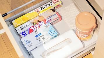 A drawer with various items including a box labeled 'S 300,' a 'NEW' box with a lemon image, and a 'COOKING' box.