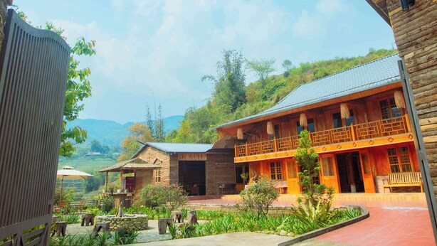 A rustic wooden archway with a sign reading "Village Innstay." - SaPa Village Retreat - Dine & Coffee (Sa Pa)