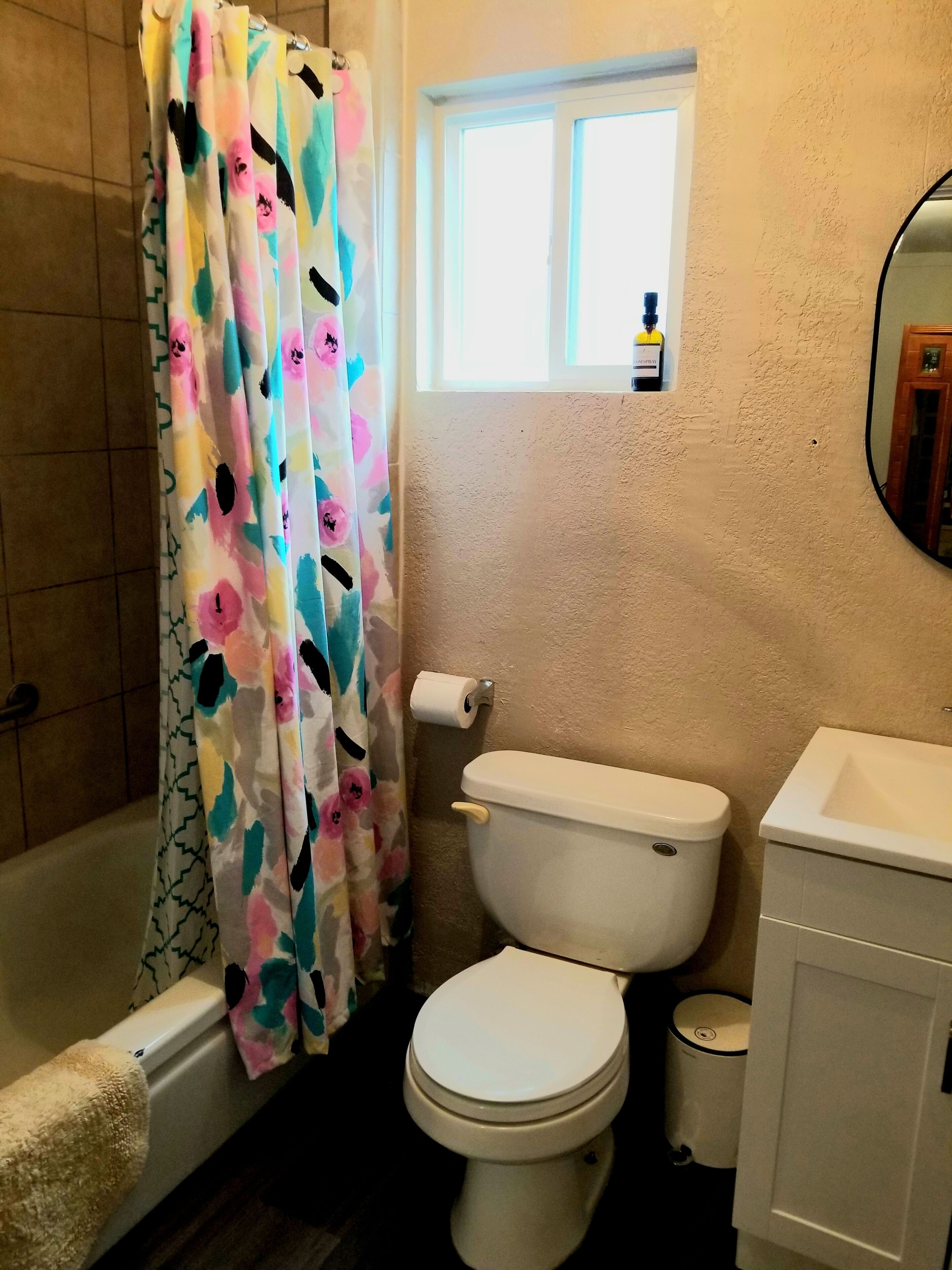 A bathroom with a bathtub, toilet, and sink.