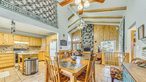 A spacious kitchen with wooden cabinets, a central island, and a dining area with a large table and chairs. - 2 Mi to Dtwn: Cloudcroft Home w/ Furnished Deck (Mayhill)