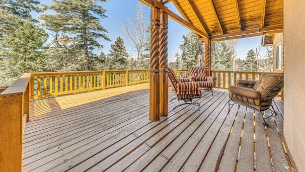 A wooden deck with a railing, two chairs, and a view of trees. - 2 Mi to Dtwn: Cloudcroft Home w/ Furnished Deck (Mayhill)