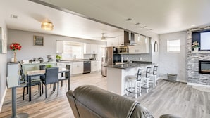 A modern kitchen with a central island, dining area with chairs, and a living space with a sofa. - 5 Mi to Dtwn: Family-Friendly Home in Roanoke! (Roanoke)