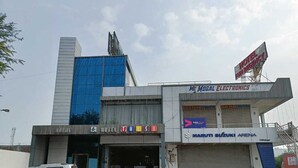 A hotel with a sign for 'Hotel Tulsi' and 'Maruti Suzuki Arena' on the ground floor. - Hotel Fun Regency (Mandal)