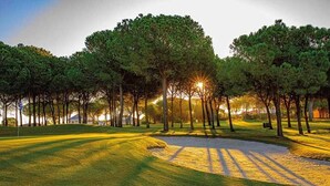 A golf course with a sand bunker, trees, and a clear sky. - Holiday Home in Castilla-León with Pool (Bernuy Salinero, Ávila)