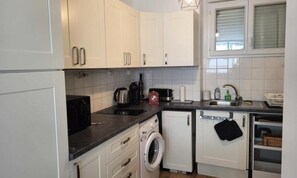 Fridge, microwave, coffee/tea maker, cookware/dishes/utensils
