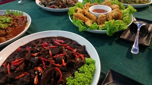 A table with various dishes, including fried chicken, a beef dish, and a salad. - The Bay Edge Resort Kota Belud (Kota Belud)