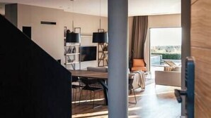 A modern interior with a staircase, a dining area, and a living space with a large window. - Villa Misto I, Spacious 5-bedroom villa with panoramic sea views, private pool & game room (Primošten)
