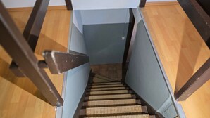 A wooden staircase with metal railings and a handrail. - Room 'Rote Pockau' with Mountain View and Wi-Fi (Marienberg OT Pobershau)