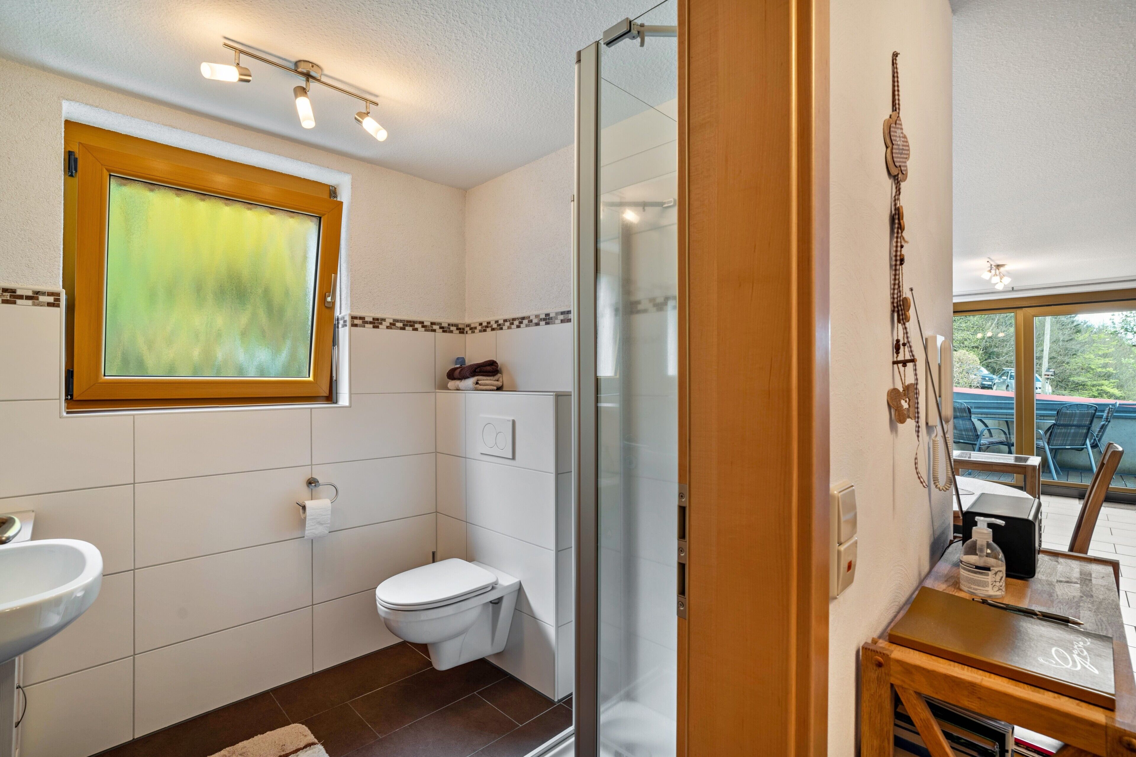 A bathroom with a toilet, sink, and shower.