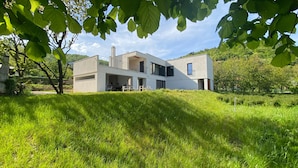 A modern two-story house with a flat roof, large windows, and a balcony. - Vila il Giardino Segreto with pool by Villas Guide (Matulji)