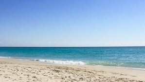 A beach with a clear sky and calm sea. - 2BR 2BTH - Apartment  - Free Parking (Sunny Isles Beach)
