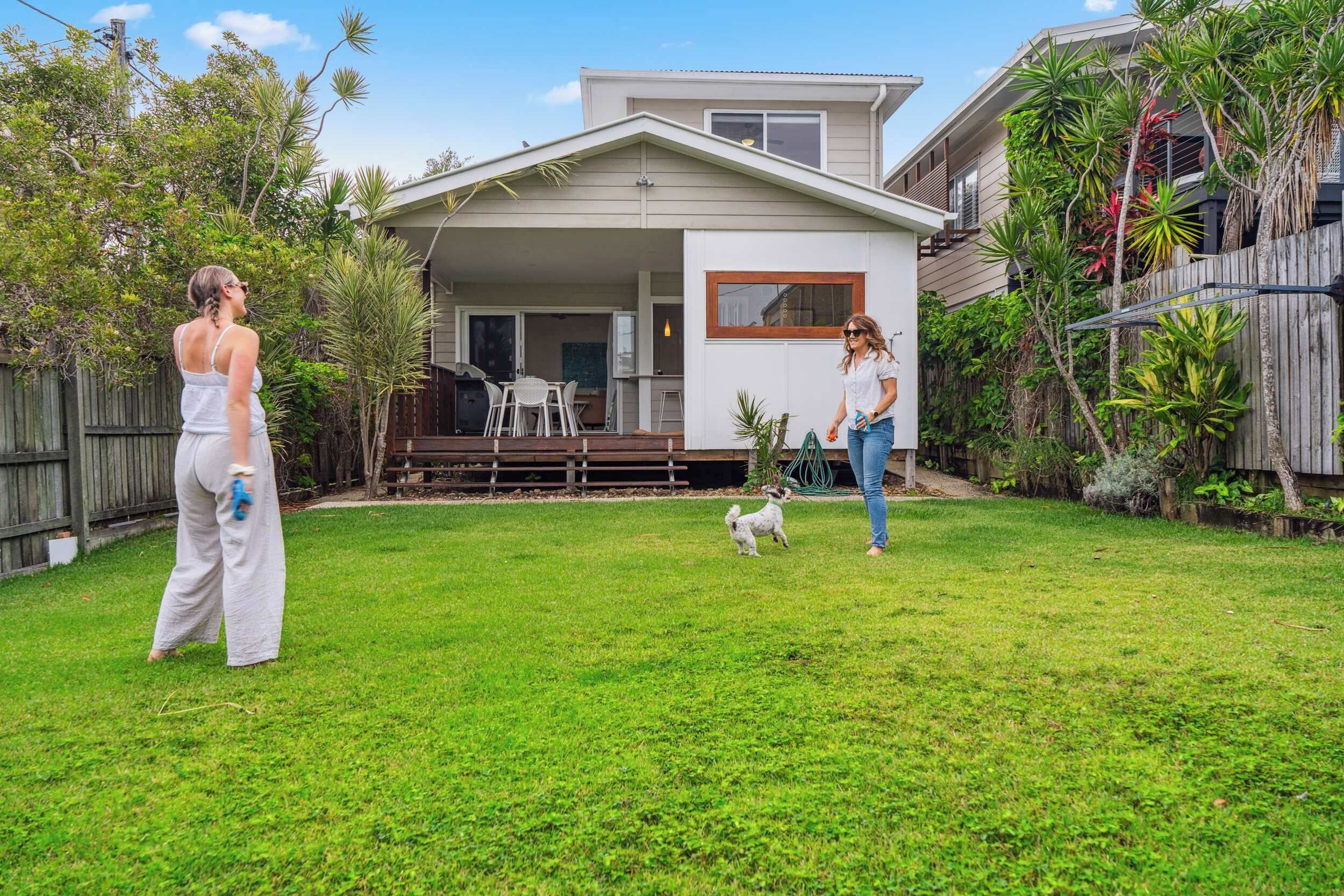 Coastal beach house exterior with lush gardens and ocean glimpses near Dicky Beach