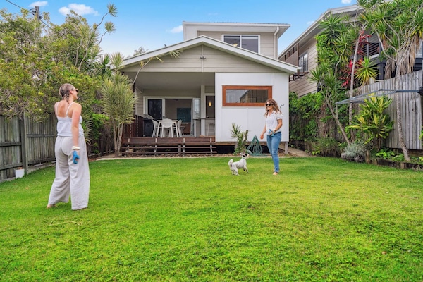 Coastal beach house exterior with lush gardens and ocean glimpses near Dicky Beach