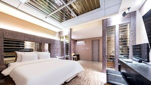 A modern hotel room with a large bed, built-in wardrobe, and a TV. - HOTEL ON (Uiwang)