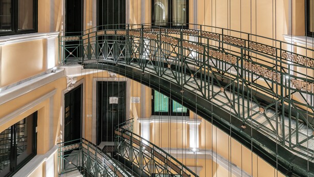 A multi-level interior with ornate railings and a reflective floor. - ExAnimo Luxury Apt 6 (Zakinthos)