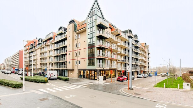 A multi-story residential building with balconies, a pedestrian crossing, and a parking area. - Apollo II 0203 met garage (NIEUWPOORT)
