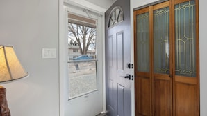 A front door with a glass panel and a wooden door with glass panels. - Unwind in this newly updated 4-bedroom home (Laramie)
