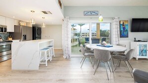 A modern kitchen with a marble countertop, stainless steel appliances, and pendant lighting. - Port Largo Villas Escape 5A (Key Largo)