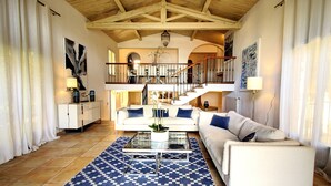 A spacious living area with a high ceiling, a staircase, and a view of the upper floor. - VILLA PALM BEACH sea front  (cannes)