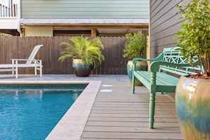 A wooden deck with a pool, a green bench, and potted plants. - Newly Built Lux Grayton Beach Home "Timeless 30A" Pool, Golf Cart, Bikes (Santa Rosa Beach)