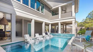 A modern two-story house with a swimming pool, outdoor seating, and a covered patio area. - Newly Built Lux Grayton Beach Home "Timeless 30A" Pool, Golf Cart, Bikes (Santa Rosa Beach)