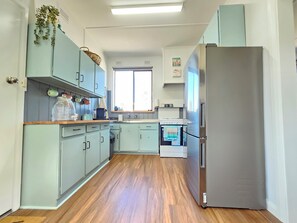 Enjoy cooking in this kitchen with an oven, sink, and wooden countertop.