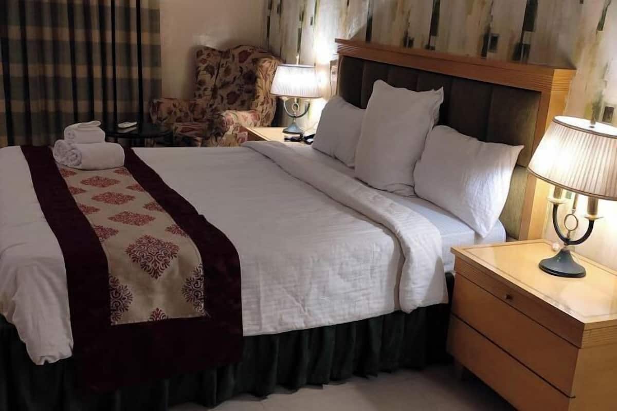 Desk, laptop workspace, bed sheets