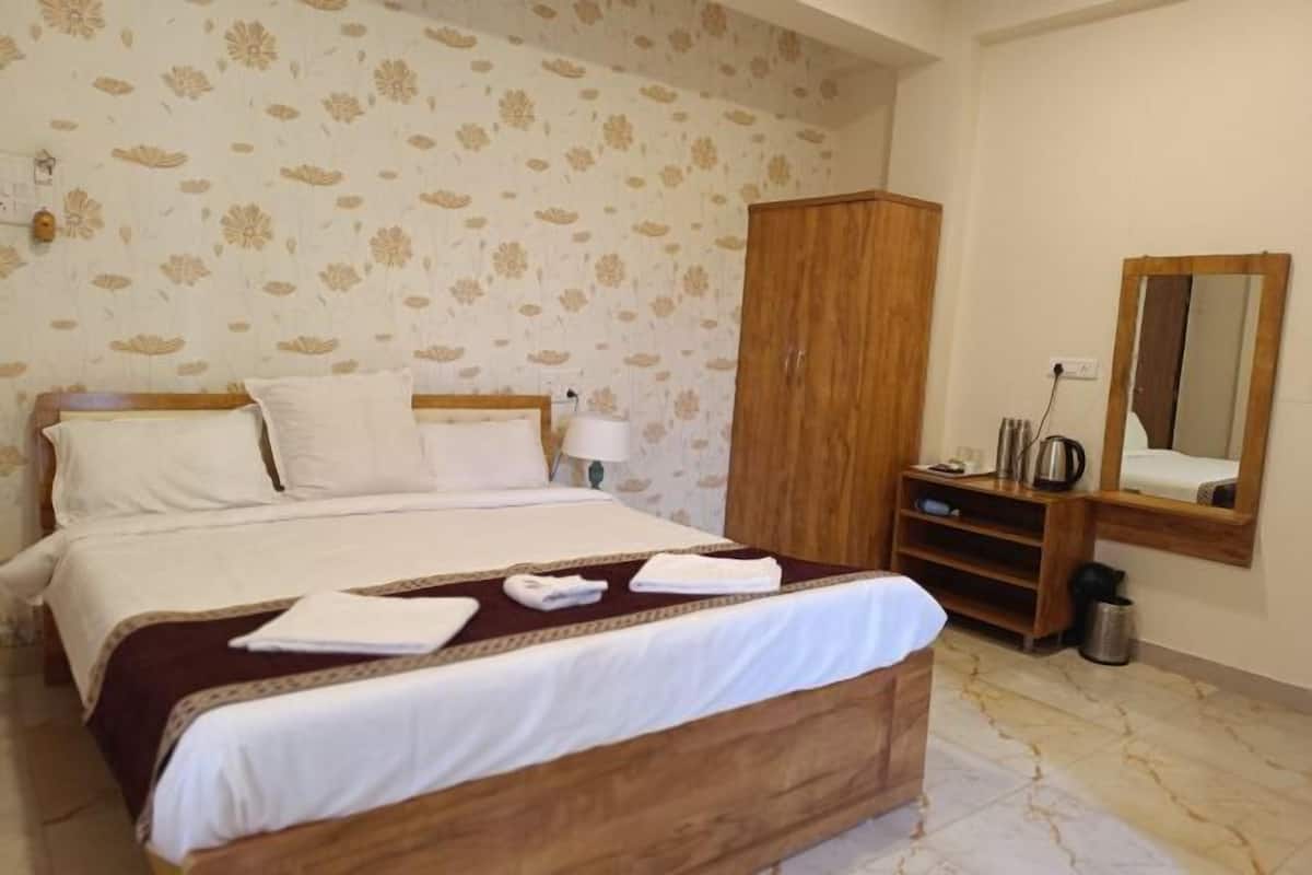 Desk, laptop workspace, bed sheets