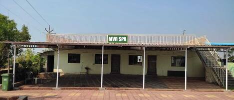 A building with a sign reading "MVR SPA" and a covered outdoor area with a staircase.
